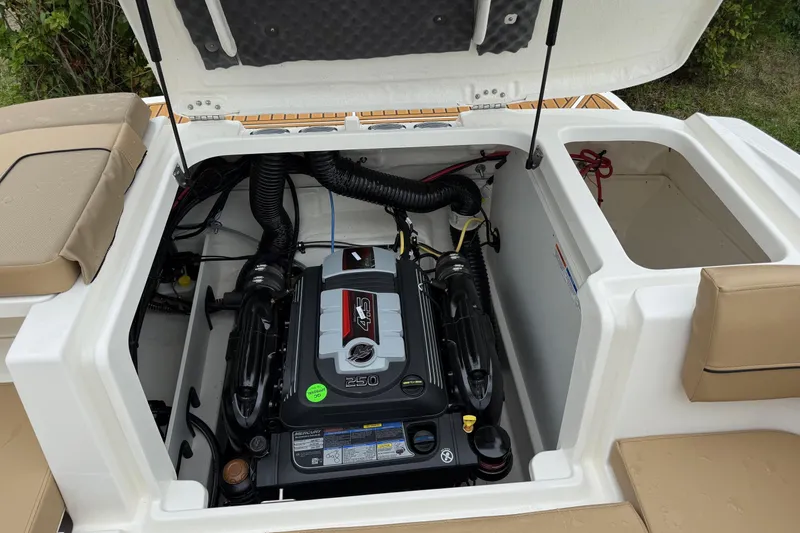 Slide: The Image of 2025 Bayliner VR6 Bowrider I/O interior with tan seating and teak-style flooring. - 6