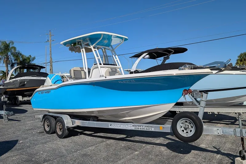 Slide: The Image of 2025 Key West 239 FS boat on trailer, vibrant blue hull, sunny day. - 0