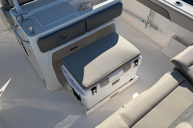 Slide: The Image of 2025 Key West 239 FS boat interior with cushioned seating and storage area. - 10