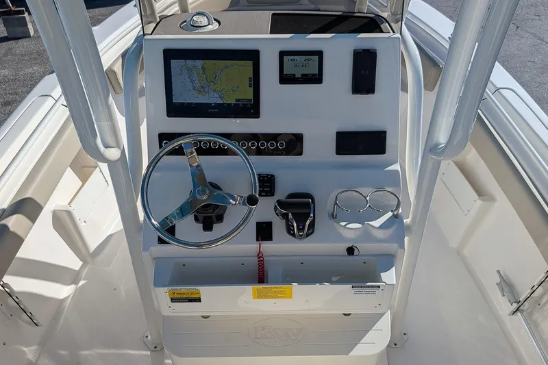 Slide: The Image of 2025 Key West 239 FS boat dashboard with steering wheel and navigation display. - 14