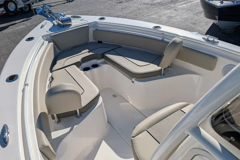 Slide: The Image of 2025 Key West 239 FS boat interior with cushioned seating and cup holders. - 16