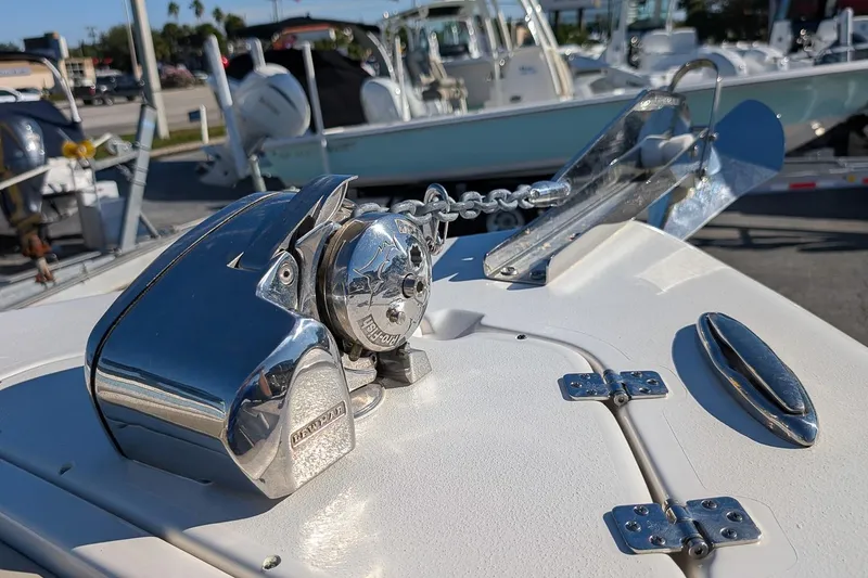 Slide: The Image of 2025 Key West 239 FS boat anchor system with chrome details in a marina setting. - 19