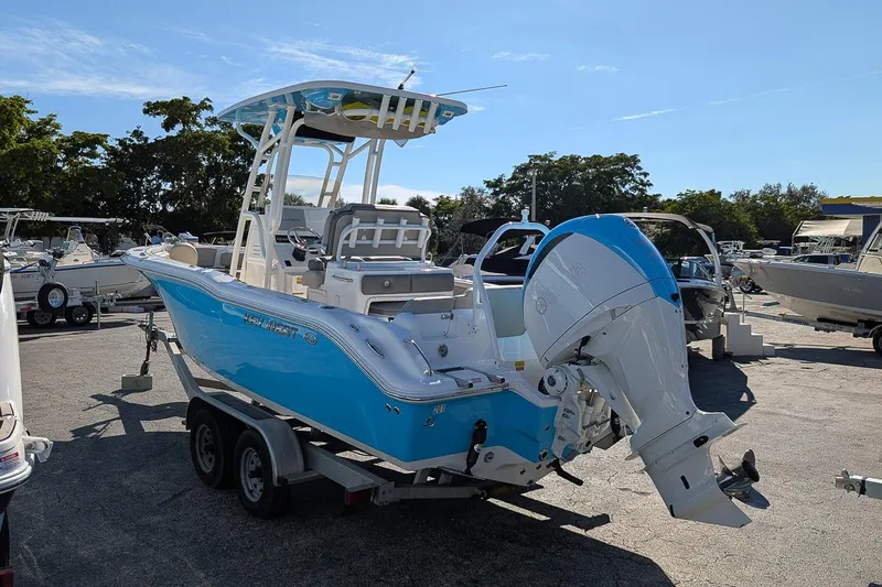 Slide: The Image of 2025 Key West 239 FS boat on trailer, blue and white design, outdoor display. - 2