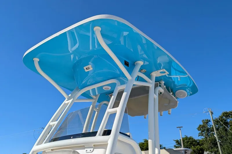 Slide: The Image of 2025 Key West 239 FS boat with blue T-top against clear sky. - 21