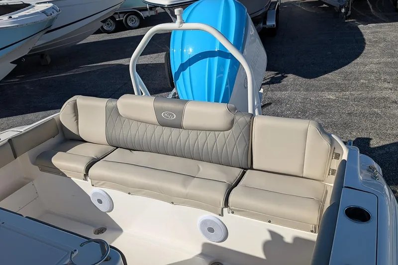 Slide: The Image of 2025 Key West 239 FS boat interior with cushioned seating and blue motor. - 7