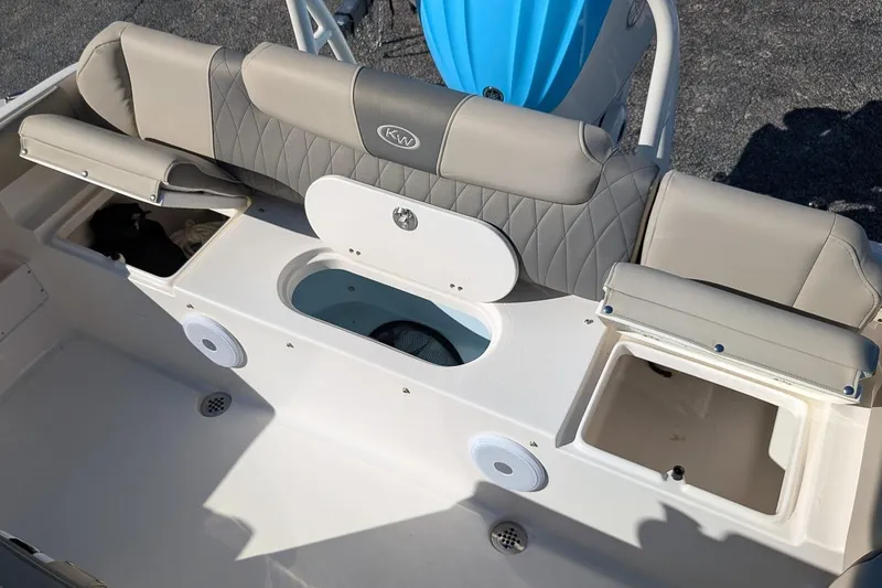 Slide: The Image of 2025 Key West 239 FS boat interior with cushioned seating and storage compartments. - 8