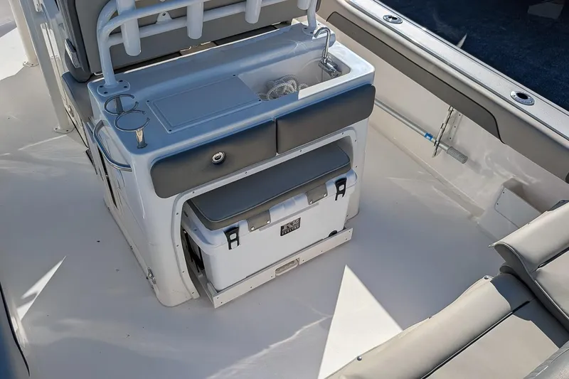 Slide: The Image of 2025 Key West 239 FS boat interior with seating, storage, and cooler. - 9