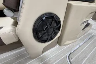 Slide: The Image of 2025 Berkshire 23ULESTS3-93 boat interior with speaker and beige seating. - 10