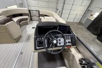 Slide: The Image of 2025 Berkshire 23ULESTS3-93 boat interior with steering wheel and seating area. - 13