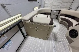 Slide: The Image of 2025 Berkshire 23ULESTS3-93 boat interior with beige seating and striped flooring. - 4