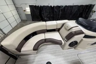Slide: The Image of 2025 Berkshire 23ULESTS3-93 boat interior with beige and brown seating. - 9