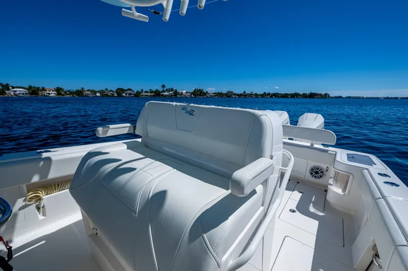 Slide: The Image of 2024 SeaVee 322z boat interior with white seating, overlooking calm blue waters. - 17