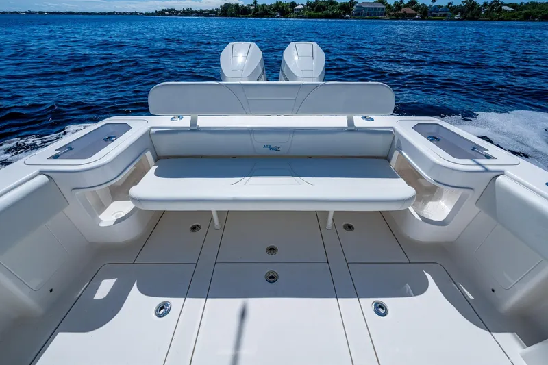 Slide: The Image of 2024 SeaVee 322z boat deck with seating, on a calm blue ocean. - 19