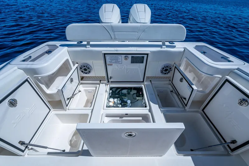 Slide: The Image of 2024 SeaVee 322z boat interior with open storage compartments on blue water. - 20