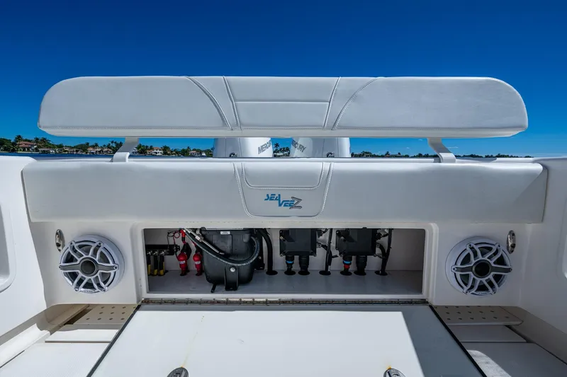 Slide: The Image of 2024 SeaVee 322z boat interior with speakers and storage compartment, under clear blue sky. - 22