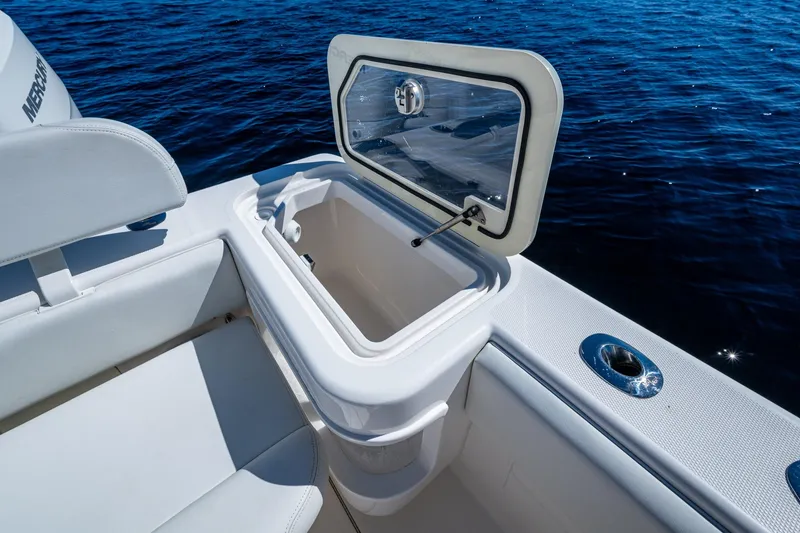 Slide: The Image of 2024 SeaVee 322z boat with open storage compartment, white seating, and ocean backdrop. - 24