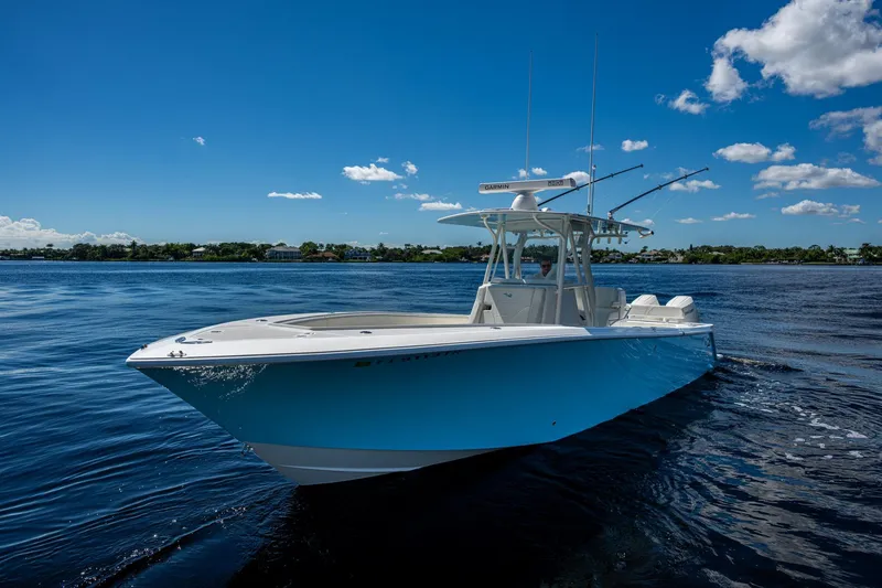 Slide: The Image of 2024 SeaVee 322z boat on calm water under a clear blue sky. - 27