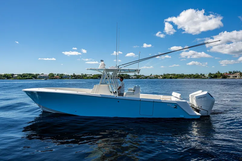 Slide: The Image of 2024 SeaVee 322z boat on calm water under a clear blue sky. - 28