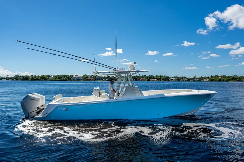 Slide: The Image of 2024 SeaVee 322z boat on calm water under a clear blue sky. - 29