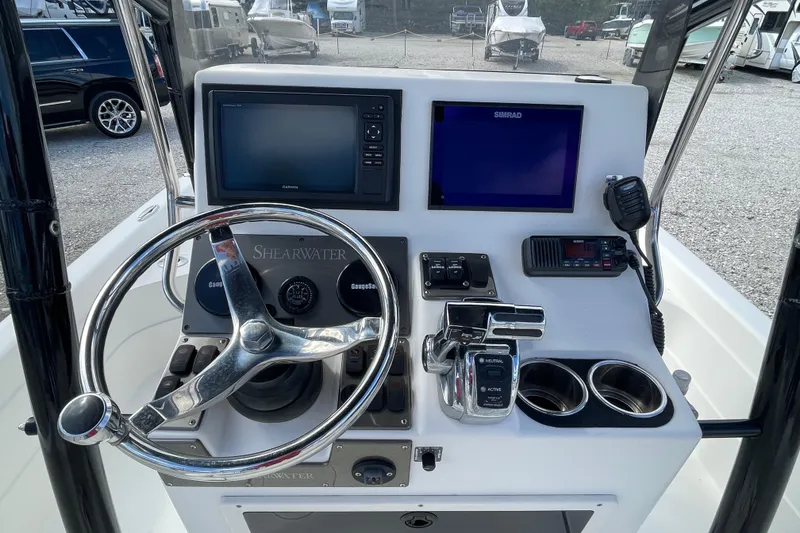 Slide: The Image of 2014 ShearWater 23TE boat with Mercury Pro XS outboard motor in a parking area. - 10