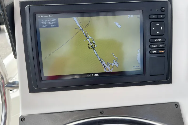 Slide: The Image of Dashboard of a 2014 ShearWater 23TE boat with Garmin and Simrad navigation displays. - 12