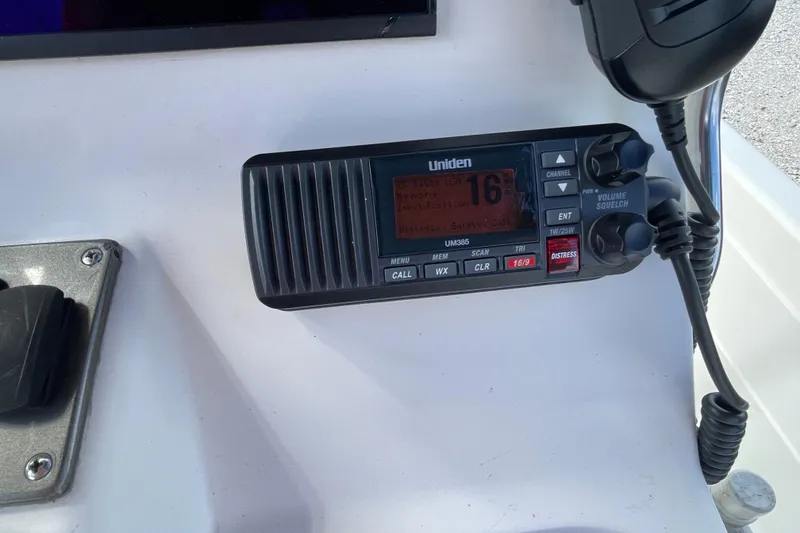 Slide: The Image of Dashboard of a 2014 ShearWater 23TE boat with RPM gauge and lift plate control. - 16