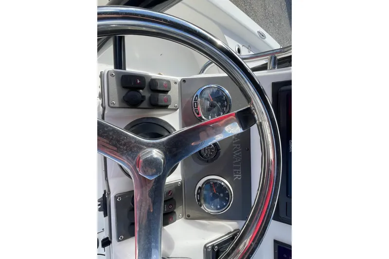 Slide: The Image of 2014 ShearWater 23TE boat with Mercury 300 engine, white seating, and RVs in the background. - 18