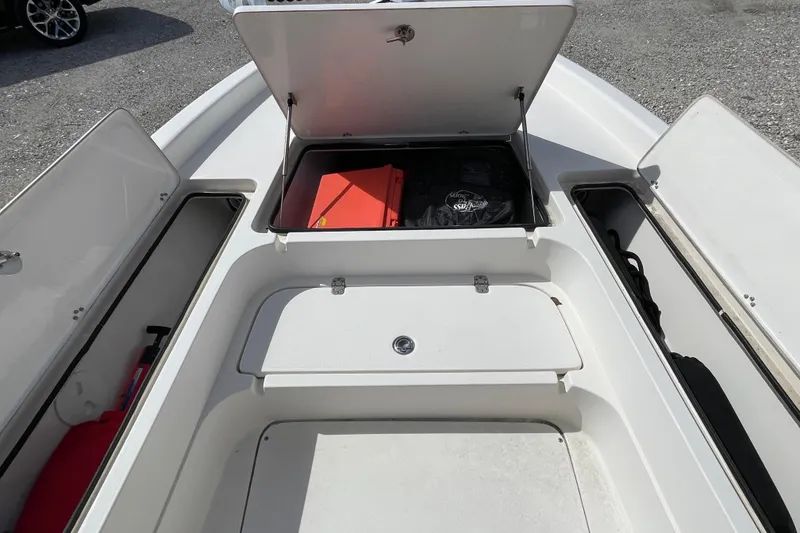 Slide: The Image of 2014 ShearWater 23TE boat with T-top and Yamaha outboard motor in a parking lot. - 25