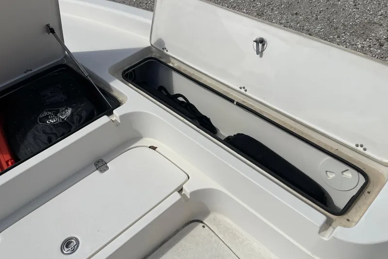 Slide: The Image of 2014 ShearWater 23TE boat storage compartments with safety equipment and gear. - 27
