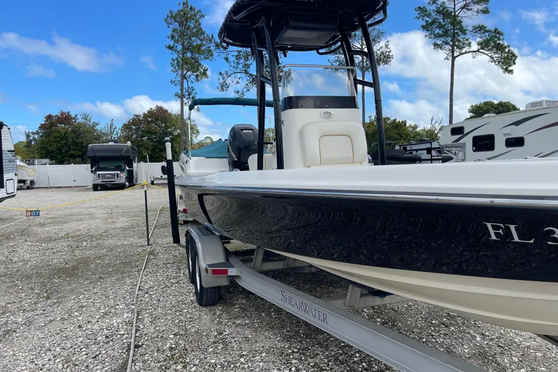 Slide: The Image of 2014 ShearWater 23TE boat on trailer in outdoor storage area. - 3