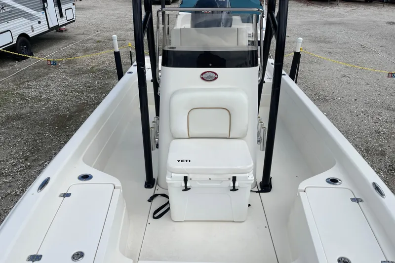 Slide: The Image of 2014 ShearWater 23TE boat with Stryker T-Tops, parked in a marina lot. - 31