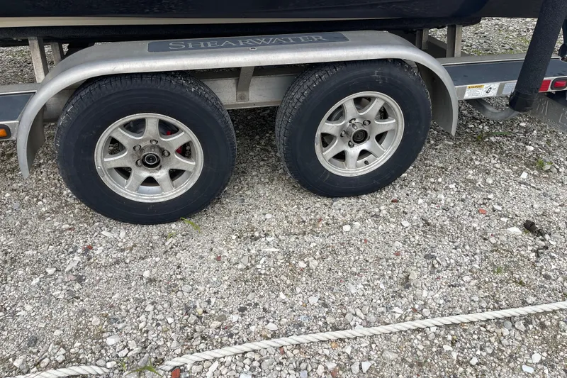 Slide: The Image of Trailer frame with AmeraTrail logo, gravel ground, ShearWater 23TE, 2014 model. - 34