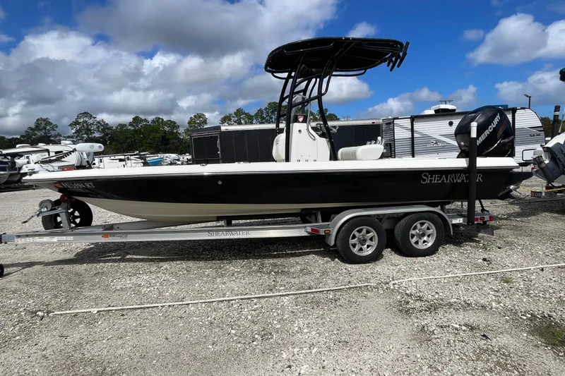 Slide: The Image of 2014 ShearWater 23TE boat hull on trailer, reflecting surroundings. - 6
