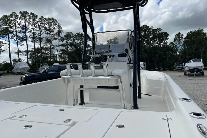 Slide: The Image of 2014 ShearWater 23TE boat on trailer, parked outdoors under cloudy sky. - 7