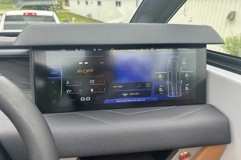 Slide: The Image of 2025 Nautique Super Air Nautique G23 dashboard display with digital controls and settings. - 11