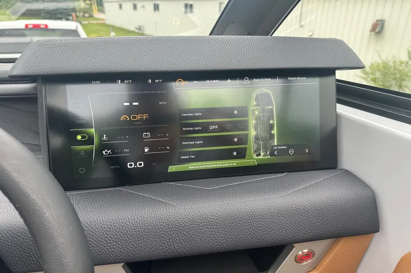 Slide: The Image of 2025 Nautique Super Air Nautique G23 dashboard display with control settings. - 16