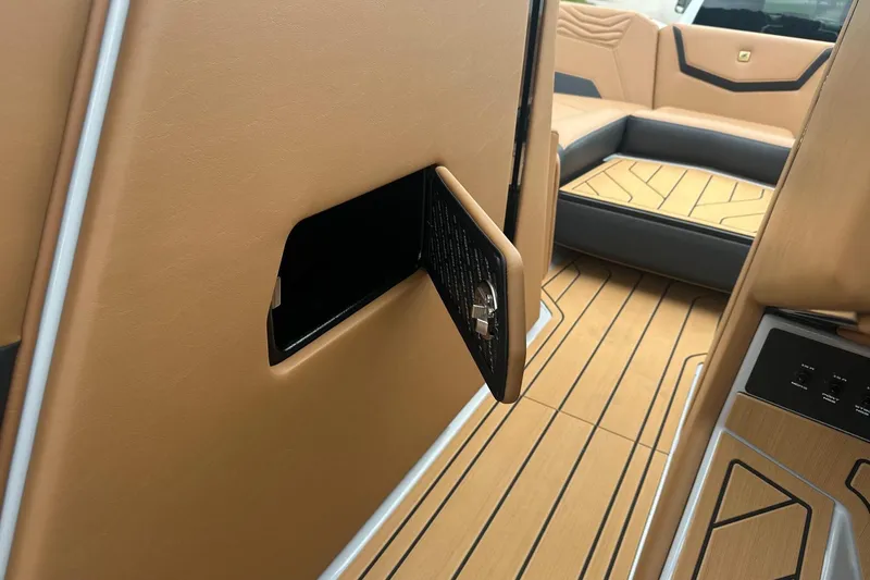 Slide: The Image of 2025 Nautique Super Air Nautique G23 interior with tan upholstery and sleek design elements. - 23