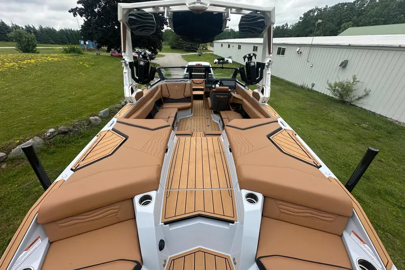 Slide: The Image of 2025 Nautique Super Air Nautique G23 boat with tan seating and sleek design. - 28