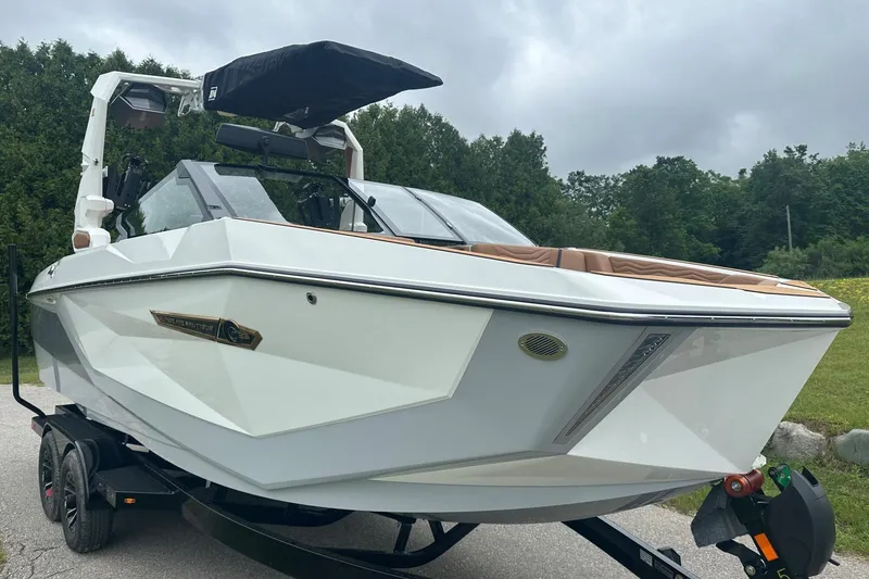 Slide: The Image of 2025 Nautique Super Air Nautique G23 boat on trailer, parked outdoors. - 3