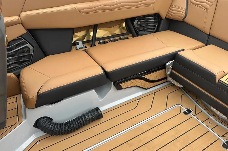 Slide: The Image of 2025 Nautique Super Air Nautique G23 interior with tan and black seating, luxury design. - 30