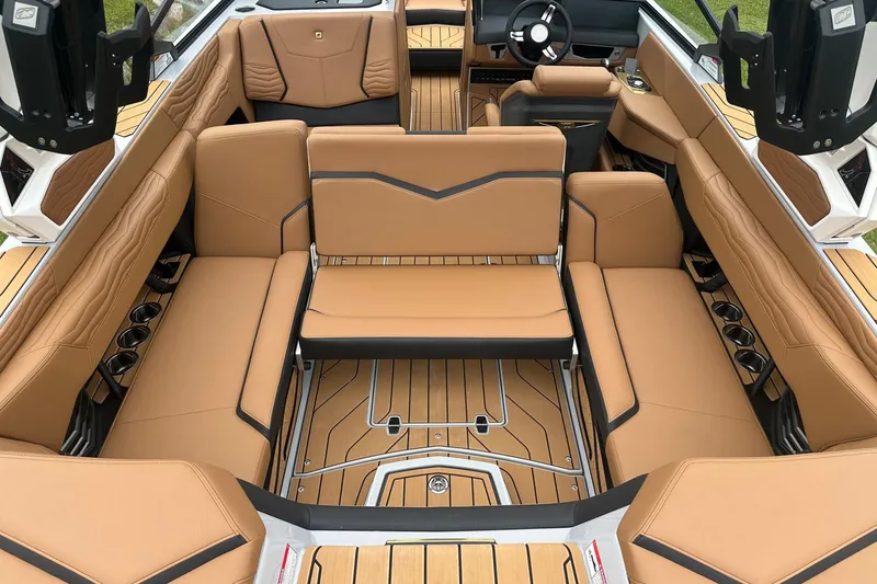 Slide: The Image of 2025 Nautique Super Air Nautique G23 interior with tan leather seating and modern design. - 33