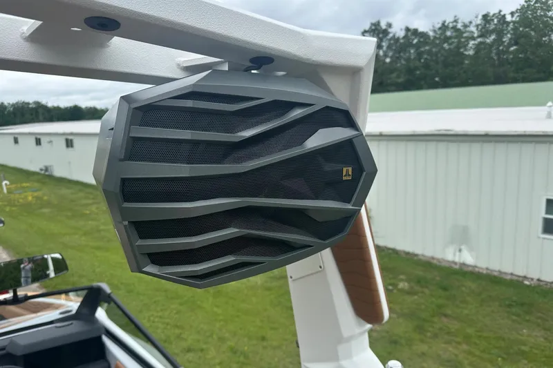 Slide: The Image of 2025 Nautique Super Air Nautique G23 boat speaker, mounted on a white frame, outdoors. - 34