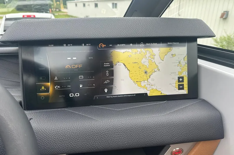 Slide: The Image of 2025 Nautique Super Air Nautique G23 dashboard with navigation display and controls. - 38