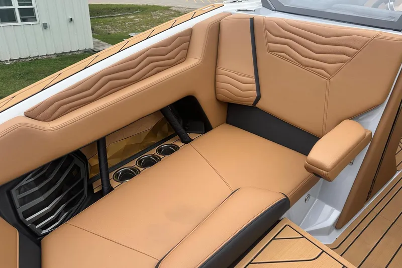 Slide: The Image of Luxurious interior of 2025 Nautique Super Air Nautique G23 boat with tan leather seating. - 43