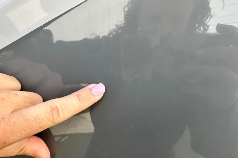 Slide: The Image of Close-up of a person pointing at the 2025 Nautique Super Air Nautique G23 surface. - 45