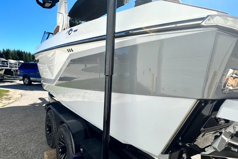 Slide: The Image of 2025 Nautique Super Air Nautique G23 boat on trailer, side view. - 47
