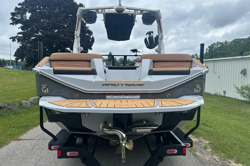 Slide: The Image of 2025 Nautique Super Air Nautique G23 boat, rear view, parked on a trailer. - 5