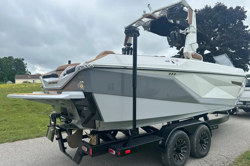Slide: The Image of 2025 Nautique Super Air Nautique G23 boat on trailer, parked outdoors. - 6