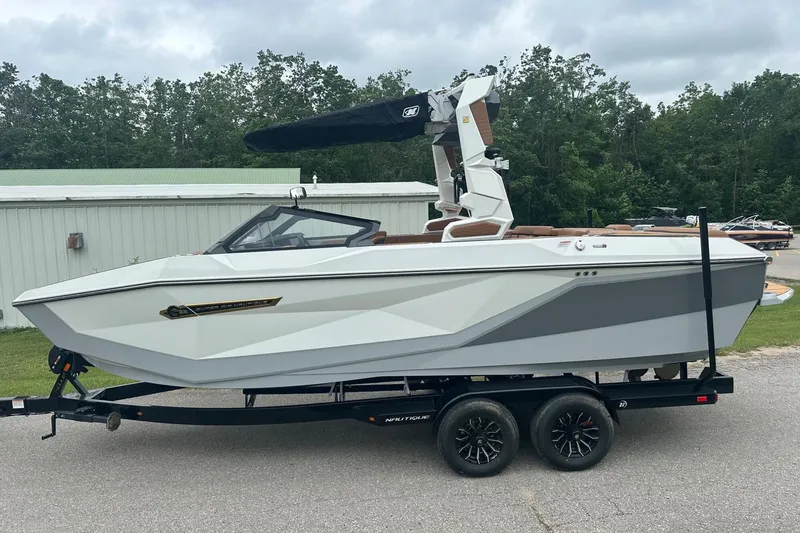 Slide: The Image of 2025 Nautique Super Air Nautique G23 boat on trailer, parked outdoors. - 7