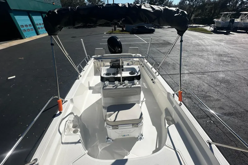 Slide: The Image of 2022 Boston Whaler 170 Montauk boat with bimini top in a parking lot. - 6